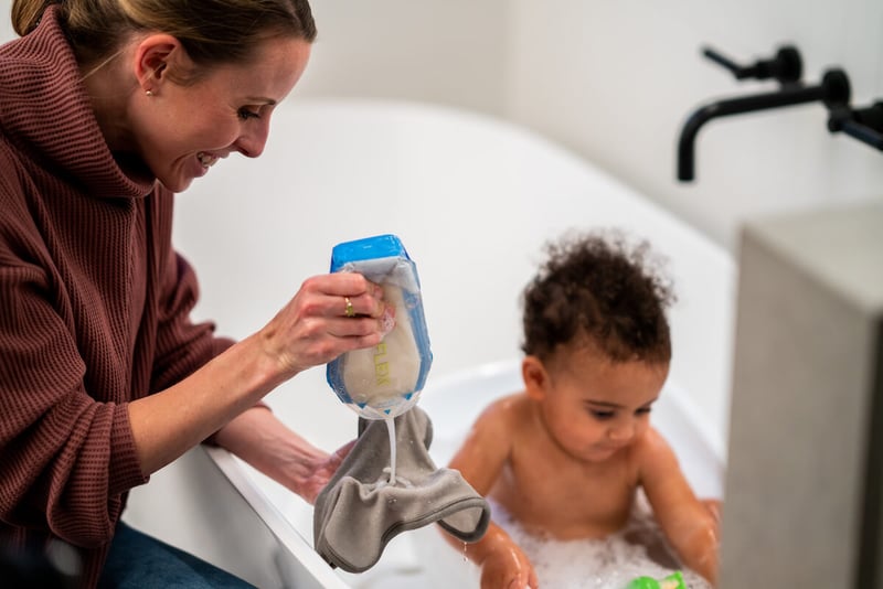 Woman squeezing baby soap onto a washcloth